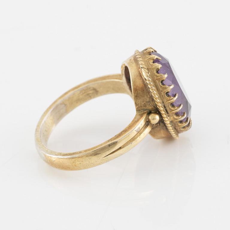 A set with a necklace, a bracelet, a brooch, and a ring.