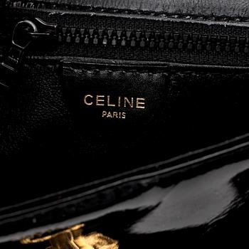 CÉLINE, a black leather patent shoulder bag.