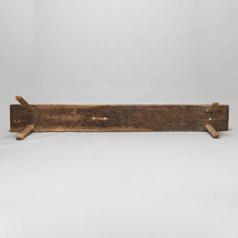 An 18th-century wooden bench dated 1782 with initials.