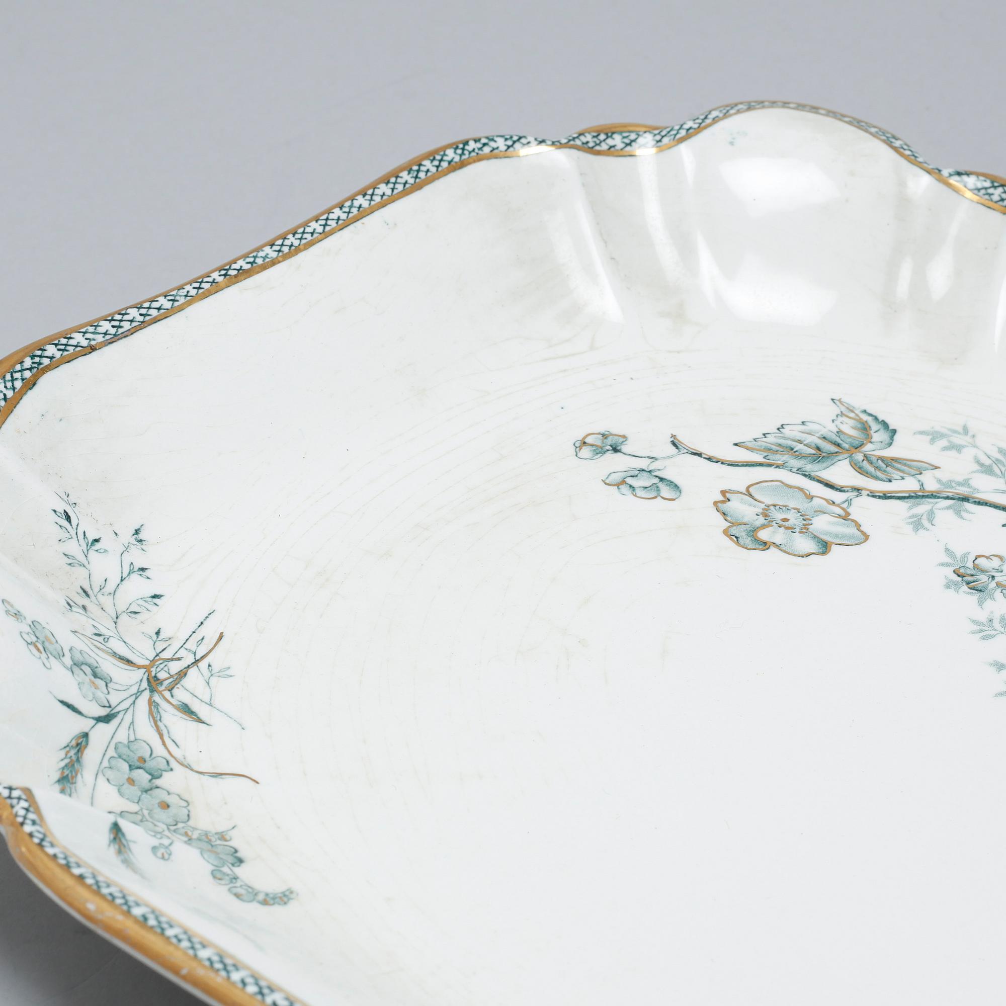 A earthenware table set of 136 pcs "Vexiö Guld",  by Arvid Ekberg, Gustafsberg, from around year 1900.