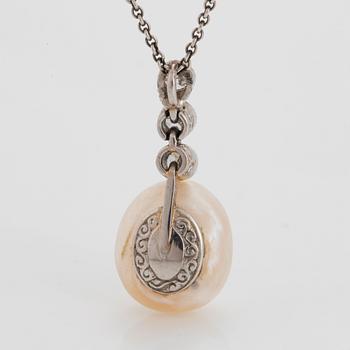 A platinum and pearl pendant set with old-cut diamonds.