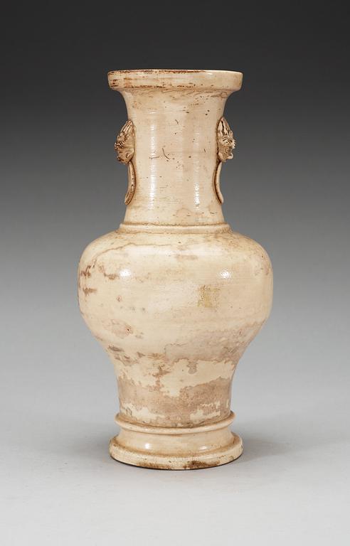 A cream glazed vase, Ming dynasty, with an inscription that dates it to 1608.