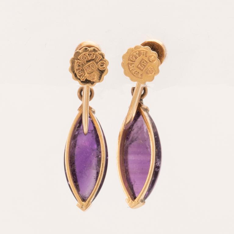 A pair of 18K gold earrings set with cabochon-cut amethysts and seed pearls, Stockholm 1961.