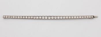 A platinum bracelet set with round brilliant-cut diamonds.