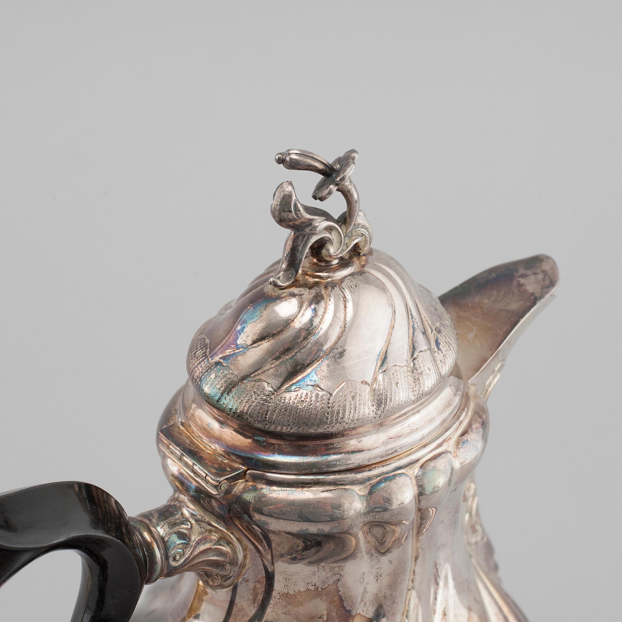 A silver rococo style coffee pot, sugar bowl and creamer from GAB and C G Hallberg in Stockholm, 1950s/60s.