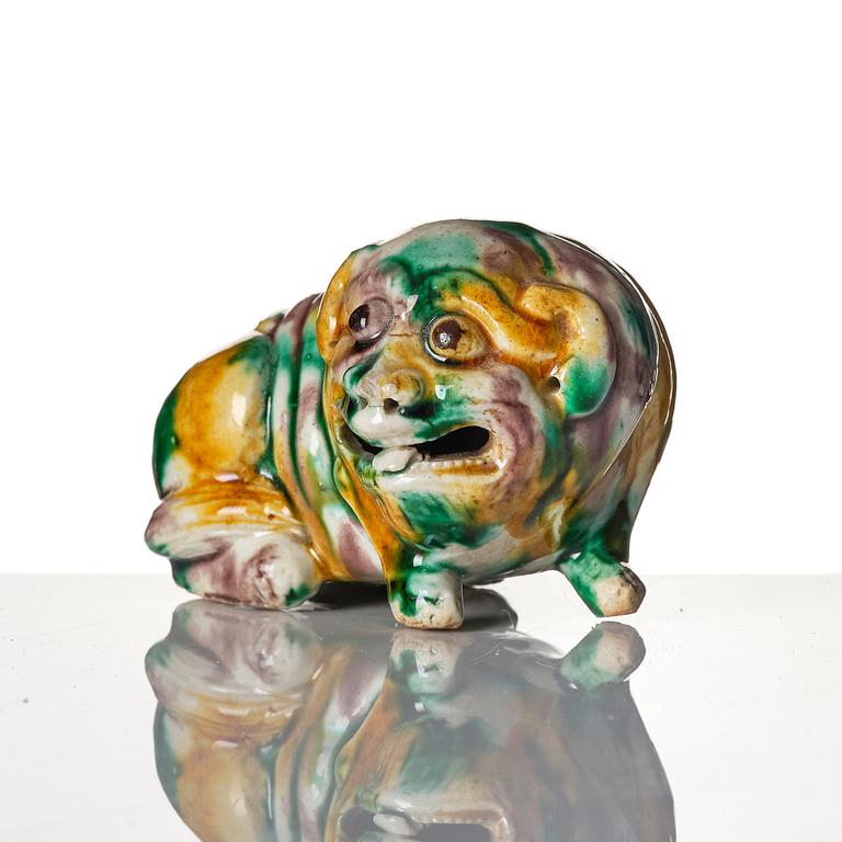 An 'egg and spinach' glazed figure of a mythical beast, Qing dynasty, Kangxi (1662-1722).