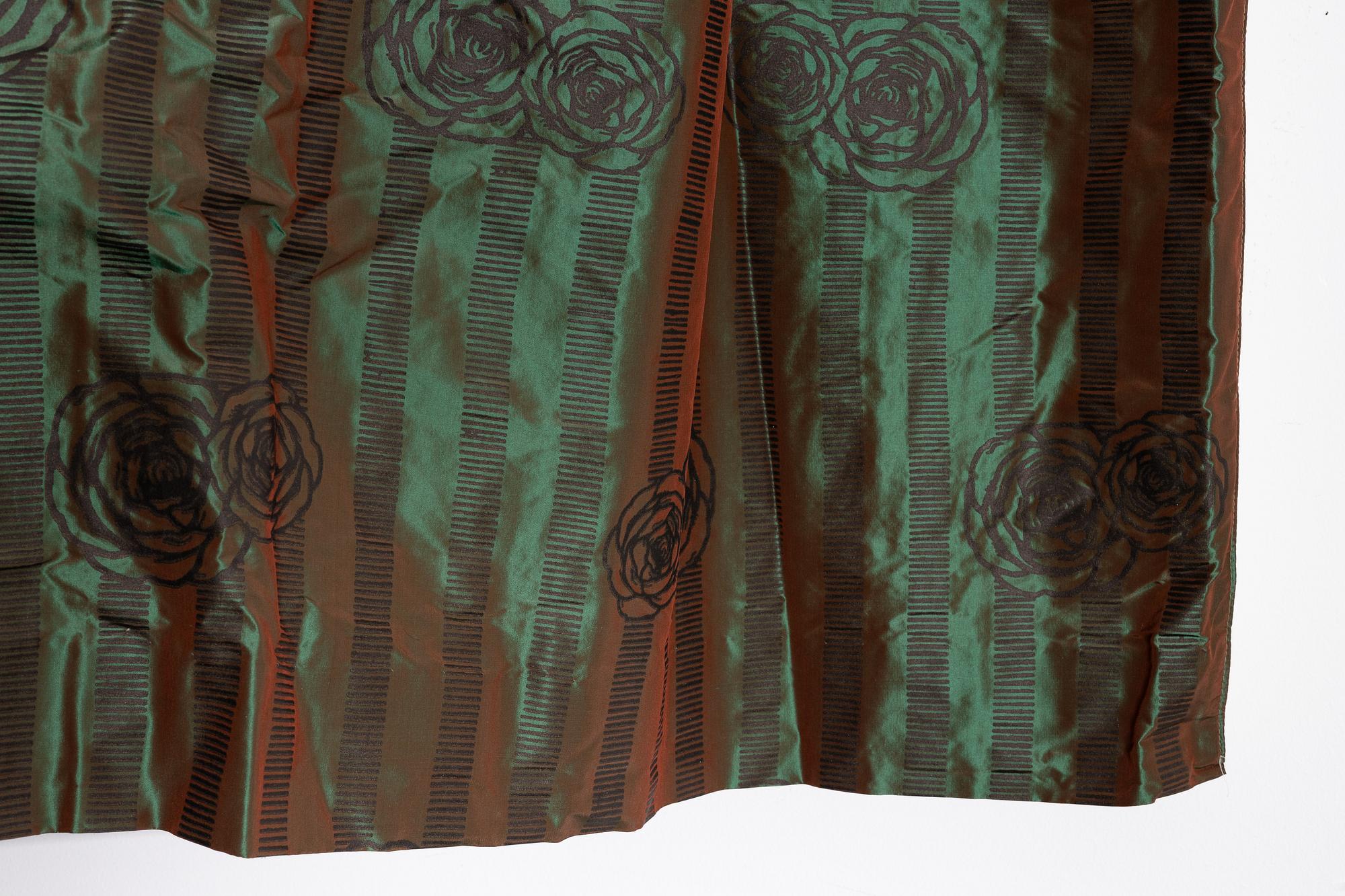 A set of four green silk curtains.