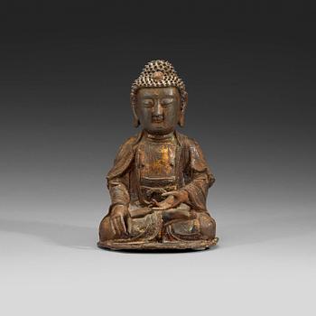 A bronze figure of a seated Buddha, late Ming dynasty (1368-1644).