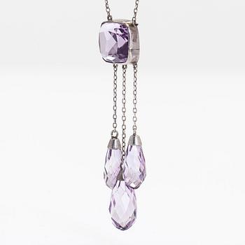 A silver and faceted amethyst necklace.