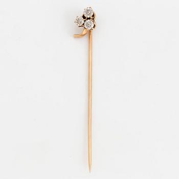 A TIE-PIN, 14K gold with three old cut diamonds.