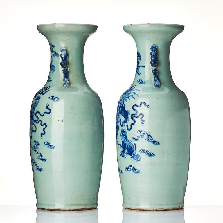 A pair of blue and white vases with celadon ground decorated with Buddhist lions, late Qing dynasty/circa 1900.