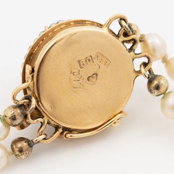 Cultured pearl necklace, double-strand with graduated pearls, Stigbert 18K gold clasp set with a cabochon-cut amethyst.