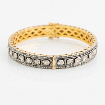 A faceted diamond bangle.