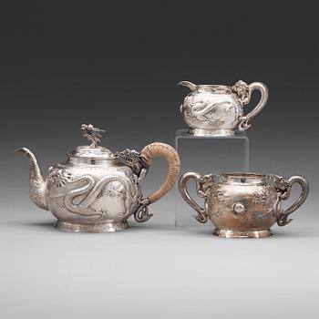 102. A Chinese three piece silver tea set, early 20th Century.