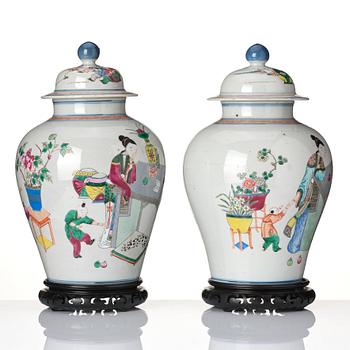 A pair of famille rose 'ladies and boys' vases with covers, late Qing dynasty.