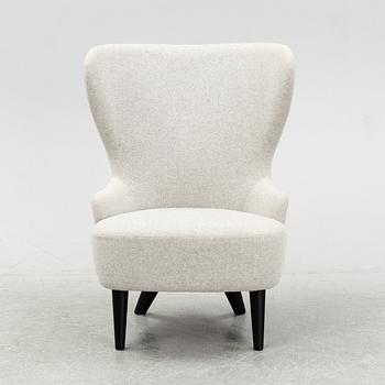 A 'Wingback Micro' easy chair by Tom Dixon.