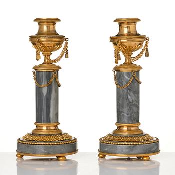 A pair of Louis XVI ormolu and Bleu turquin candlesticks.