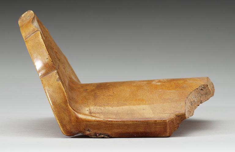 A yellow glazed end-tile, with dragon in relief, Ming dynasty (1368-1644).