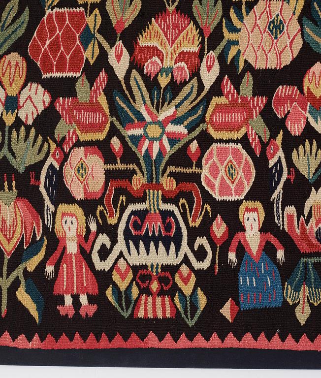 A carrige cushion, 'Urnor & par',  tapestry weave, c. 110 x 53 cm (with mounting 115 x 57 cm), circa 1800-1825.