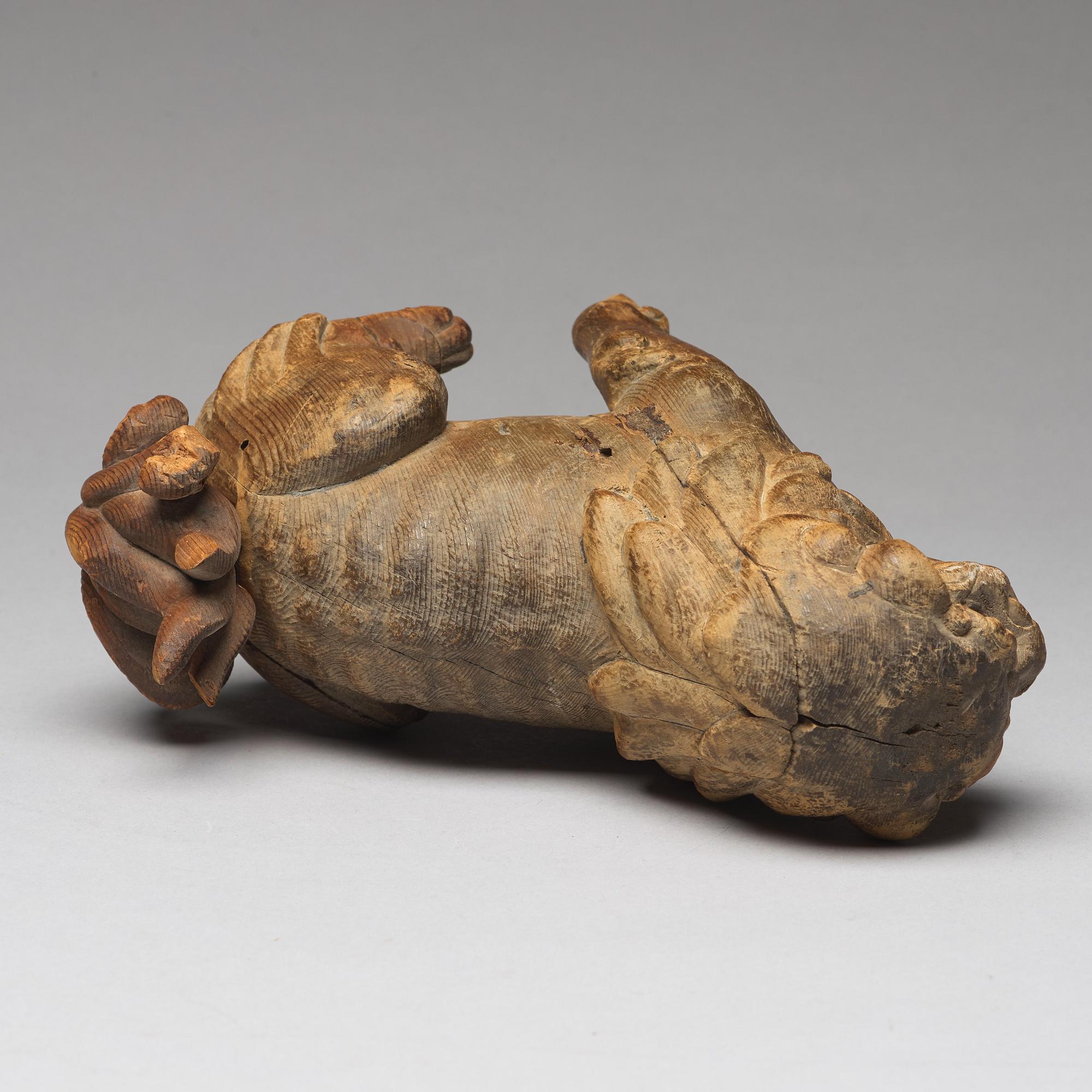 A wooden sculpture of a buddhist lion, Qing dynasty, 19th Century.