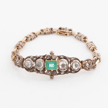 A 14K gold and silver bracelet set with an emerald and rose-cut diamonds.