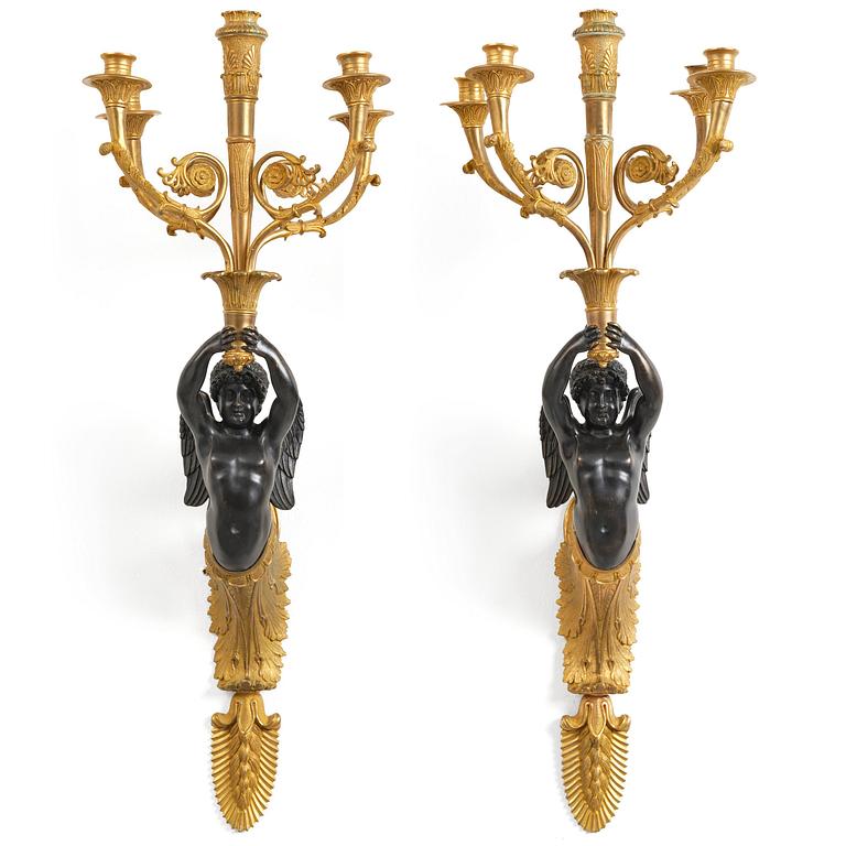 A pair of Napoleon III five-branch gilt and patinated bronze appliques.