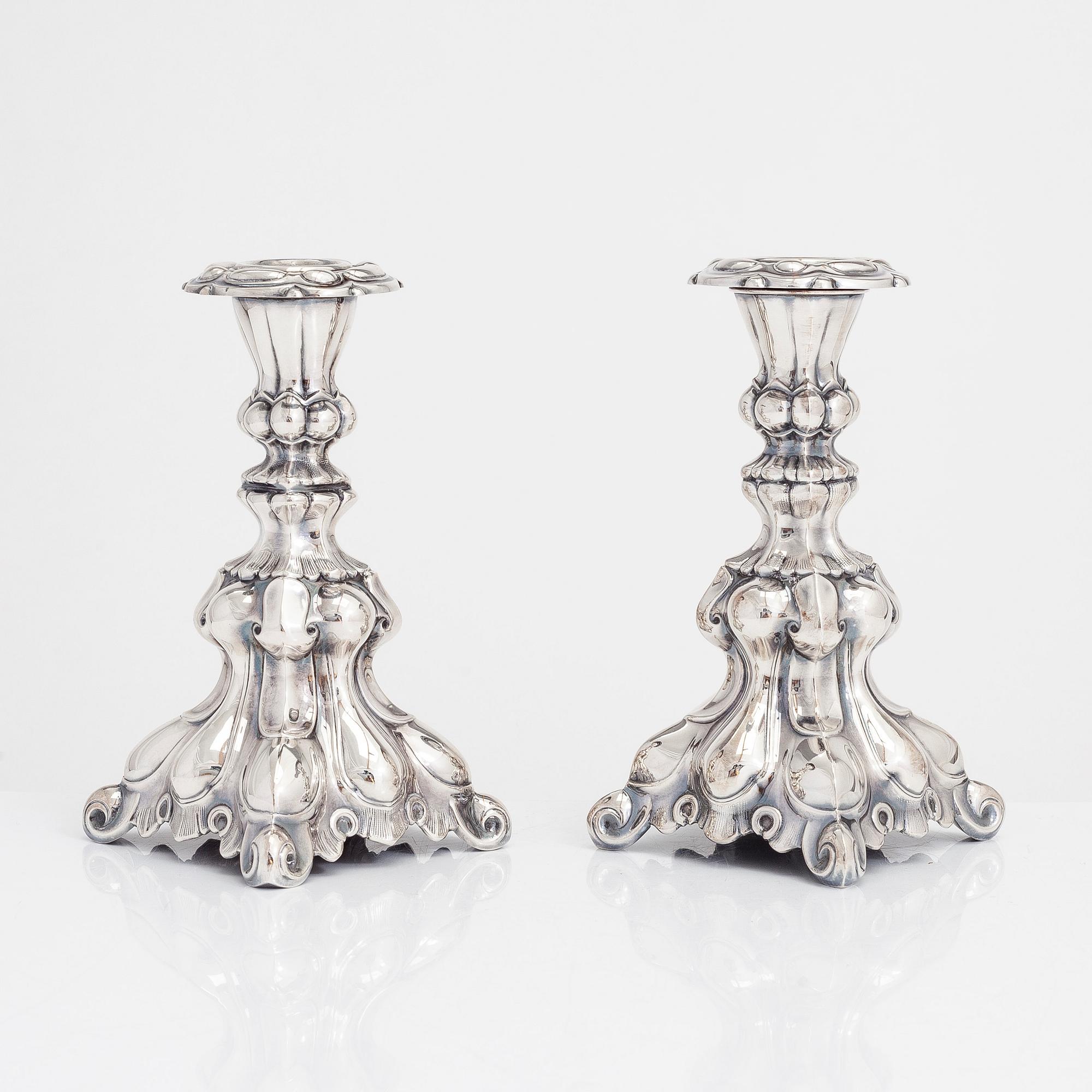 Two similar baroque style silver candlesticks by Kultakeskus, Hämeenlinna 1948 and Hopeatehdas Oy, Helsinki 1953.