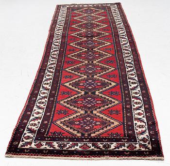 An oriental runner, c. 395 x 100 cm.