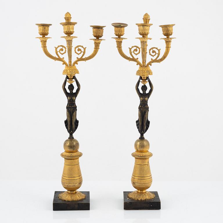 A pair of bronz empire style candelabras, 19th Century.