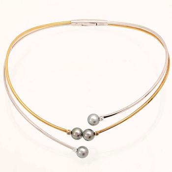 An 18K white- and yellow gold necklace with round brilliant cut diamonds and cultured Tahitian pearls, Damiani Italy.
