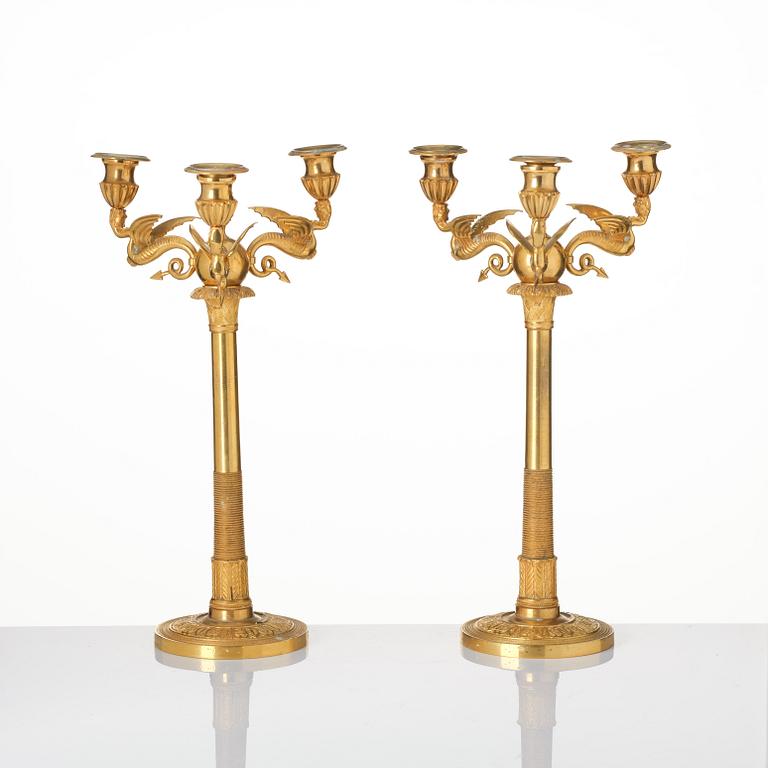 A pair of three-branch Empire-style ormolu candelabra, 19th century.