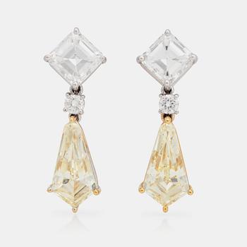 A pair of Fancy Light Yellow and colourless diamond earrings. Total carat weight 8.07cts.