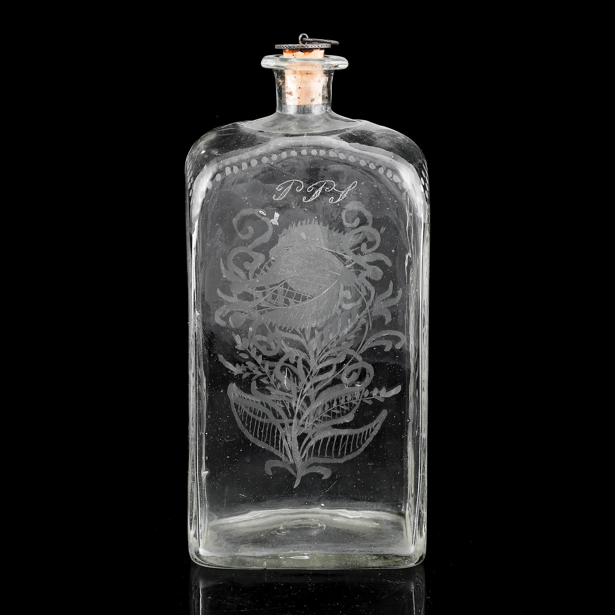 A glass bottle and three vodka glasses, 19th Century.