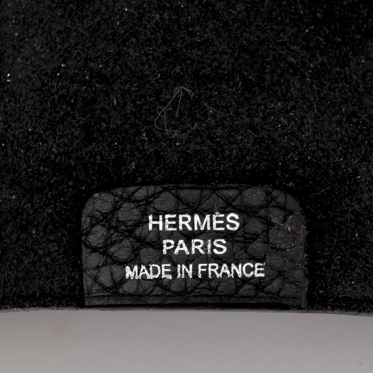 HERMÈS, a black leather notebook, "Ulysse Petit Modèle".