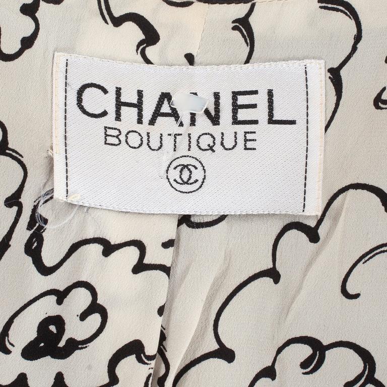CHANEL, a three-piece suit consisting of jacket, top and skirt.