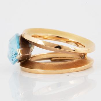 18K gold and navette shaped blue topaz.