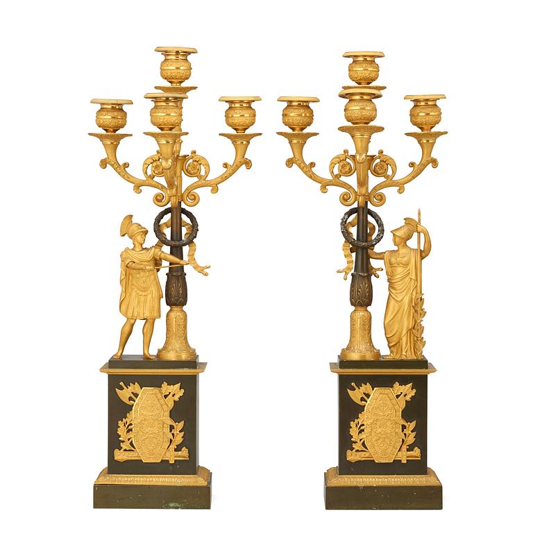 A pair of French Empire early 19th century gilt and patinated bronze four-light candelabra.