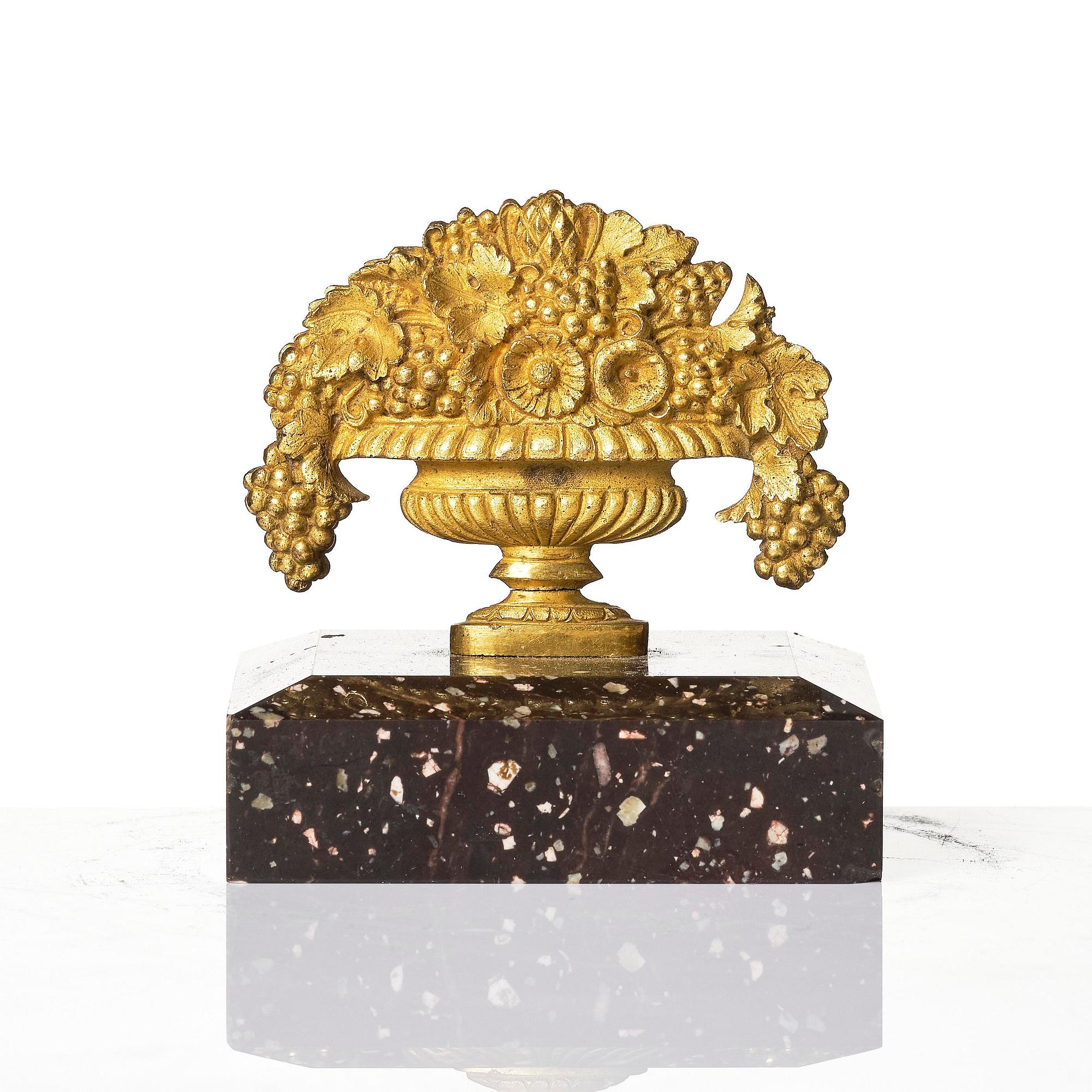 An Empire 'Loka-Risberg'-porhyry and ormolu paperweight, Älvdalen, early 19th century.