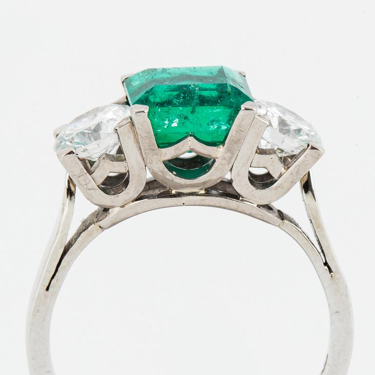 Emerald and brilliant-cut diamond three stone ring.