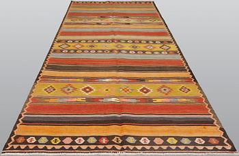 A semi-antique Nomadic Kilim rug, approx. 383 x 153 cm.