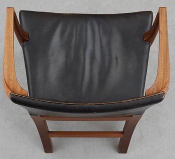 A Kaare Klint mahogany and black leather armchair by Rud Rasmussen snedkerier, Denmark.