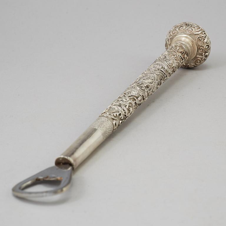 A silver handle for a cane, remodeled in to a can opener, China, 20th Century.