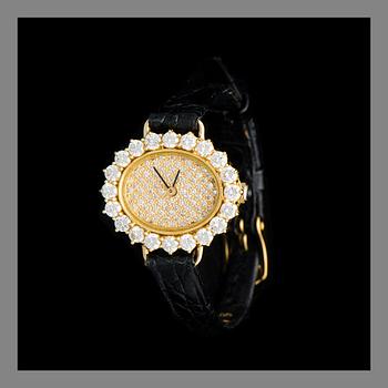 A LADIES´ WRISTWATCH, gold, brilliant cut and 8/8-cut diamonds, black leather stripe.