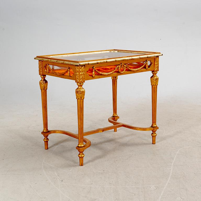 A gilded Louis XVI style display table first half of the 20th century.