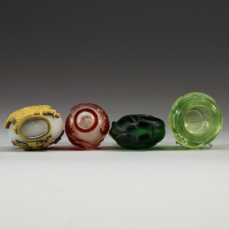 A set of three Peking glass snuff bottles with stoppers and a brush washer.