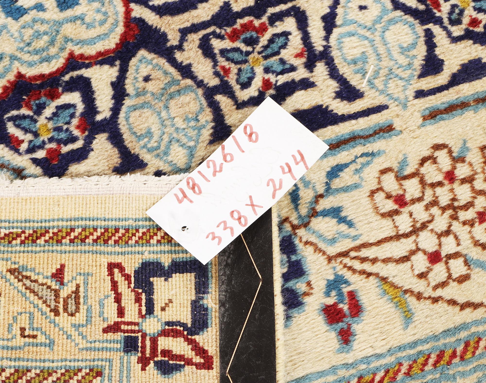 A Nain carpet, part silk, c. 338 x 244 cm.