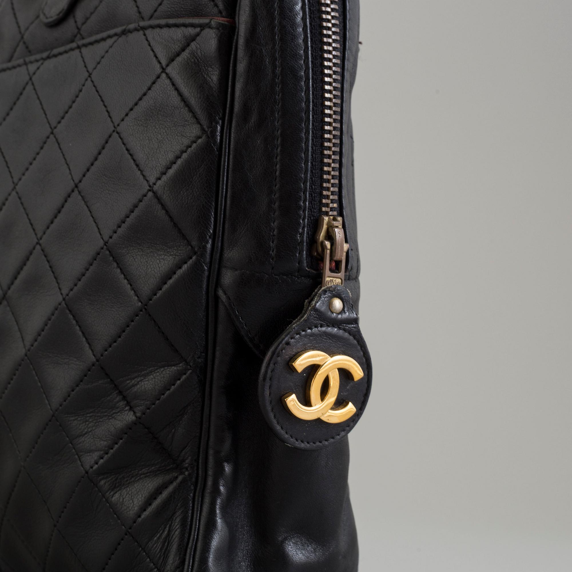 a CHANEL black leather bag.