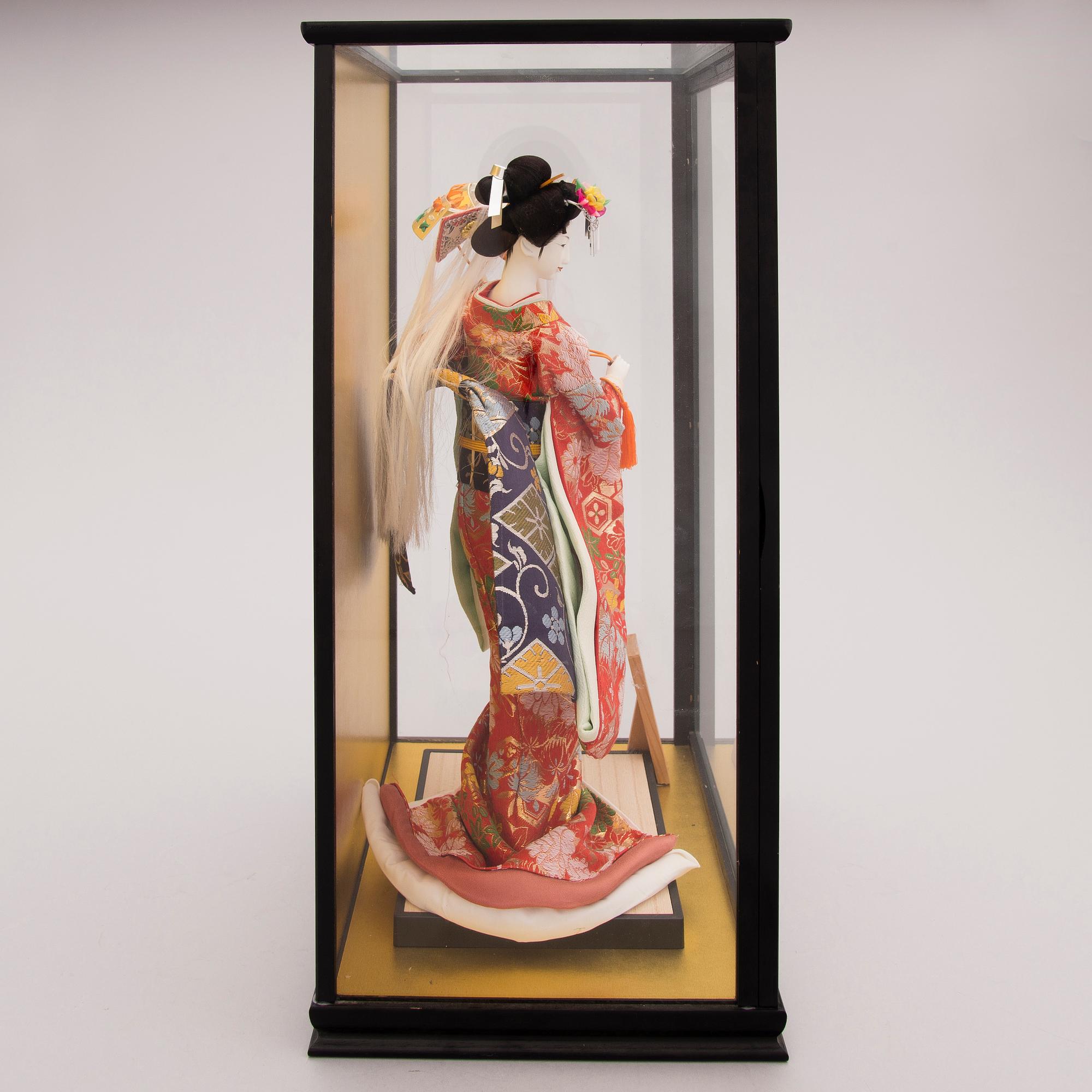 A latter half of the 20th century Japanese doll in showcase.
