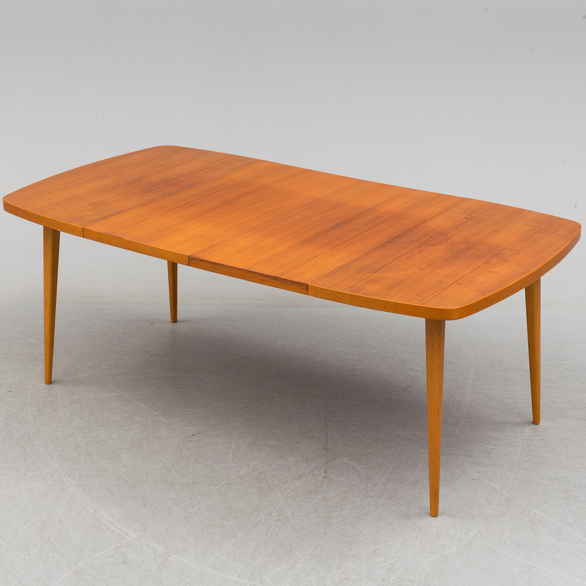 A 1950s teak and teak veneer table.
