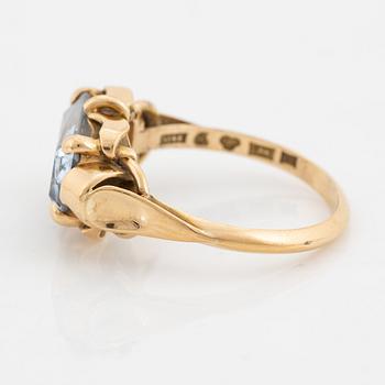 An 18K gold ring set with a synthetic spinel.